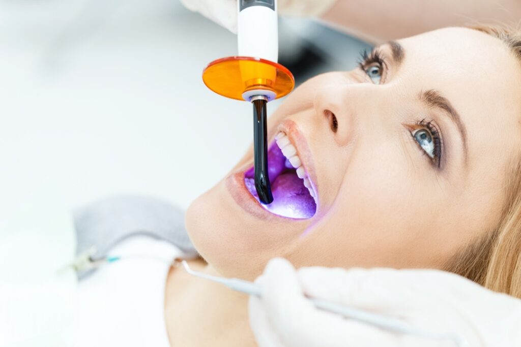 Woman having a cavity filled at the dentist
